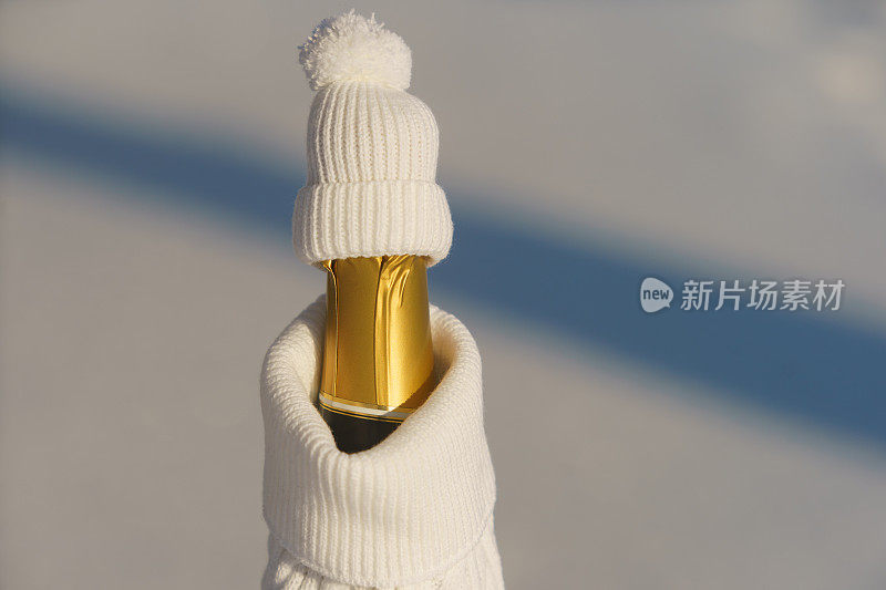 Сhampagne bottle formed as a human figure dressed in warm snow-white winter clothes.